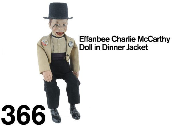 Effanbee Charlie McCarthy Doll in Dinner Jacket: cloth dressed doll with painted composition head, hands, and shoes; an exceptional example in a scarce formal dress: white dinner jacket with purple cummerbund; has 2 original Effenbee pinbacks 19" t.