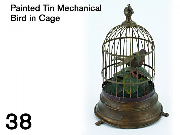Painted Tin Mechanical Bird in Cage: painted tin wind-up spins and flaps wings accompanied by chirping 9.25" t.