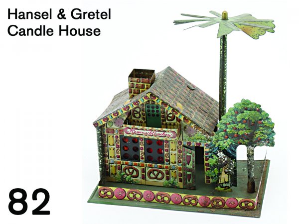 Hansel & Gretel Candle House: beautifully embossed lithographed tin, heat from candle turns vane causing the children to go into the house followed by the witch 7.5" w., 8" t.
