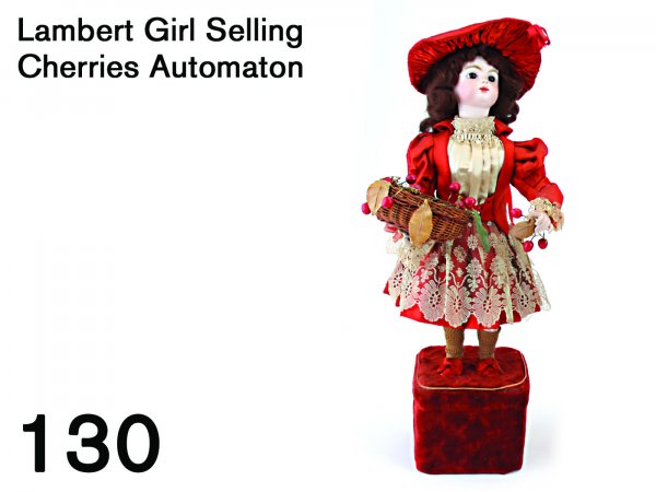 Lambert Girl Selling Cherries Automaton: made by Lambert of Paris circa 1890, the doll has a bisque head by Gaultier (marked "FG"0 with closed mouth and fixed brown glass eyes, her bisque hands hold a cherry sprig in one hand and a cherry ba