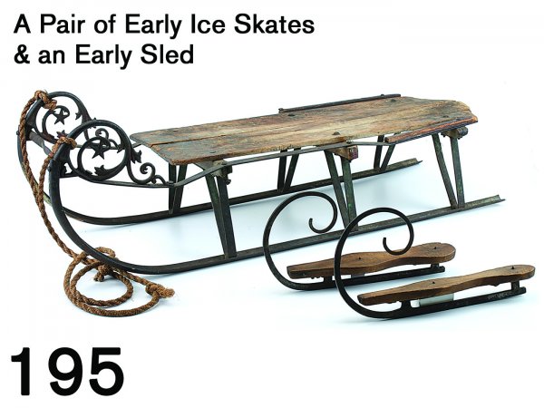 A Pair of Early Ice Skates & an Early Sled: wood soled skates with steel runners, runners are grooved beneath the sole before turning into a wonderful high prow, sole has very small remnants of original leather straps; offered along with a char