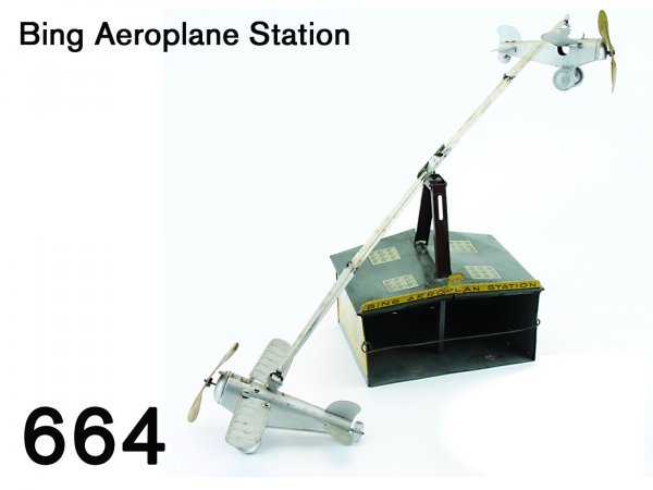 Bing Aeroplane Station: Bing Aeroplane Station lithographed tin building marked "Bing Aeroplane Station" with 2 planes - one with clockwork mechanism, they fly around roof mounted stanchion building 9" x 6.5"
