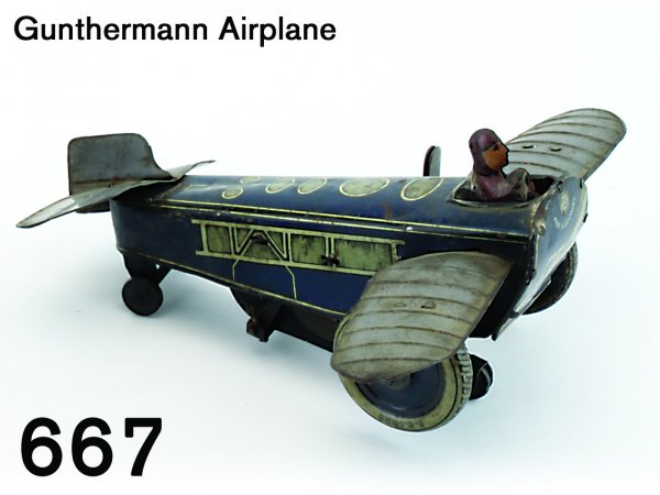 Gunthermann Airplane: Gunthermann Airplane lithographed tin clockwork plane with pilot, plane rolls then pops up 6.5" l.