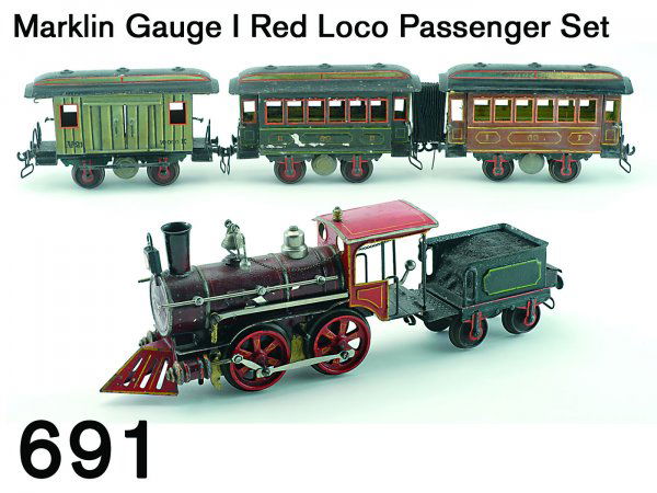 Marklin Gauge I Red Loco Passenger Set: Marklin Gauge I Red Loco Passenger Set American steam profile 0-4-0 clock work engine with maker's emblem on boiler front, brake lever and whistle chain in very scarce maroon and red (some paint chipp