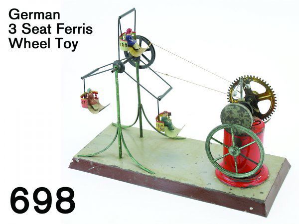 German 3 Seat Ferris Wheel Toy: German 3 Seat Ferris Wheel Toy painted tin and wire with painted composition riders, powered by a complex faux-steam plant with flywheel, governor, and geared drive wheel; operated by pull string, 'bo