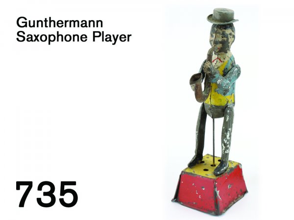 Gunthermann Saxophone Player: Gunthermann Saxophone Player painted tin with clockwork, as 'plink-plunk' music plays the player's hat revolves 9.5" t.