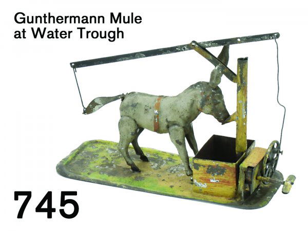 Gunthermann Mule at Water Trough: Gunthermann Mule at Water Trough painted tin with clockwork, mule drinks at water spout while wagging tail and ears 7" l.