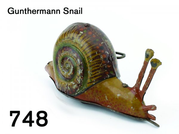 Gunthermann Snail: Gunthermann Snail very colorful lithographed tin with clockwork mechanism, great detail, "SG" on innermost curl of shell, great action: snail proceeds with clicking noise then turns randomly and rever