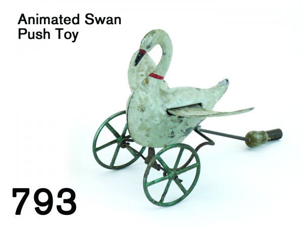 Animated Swan Push Toy: Animated Swan Push Toy finely crafted painted tin swan on cast metal wheels, tube in rear for insertion of stick to make a push toy, swan flaps wings as it moves forward 5" t.