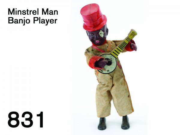 Minstrel Man Banjo Player: Minstrel Man Banjo Player this cloth dressed clockwork toy is made of tin and celluloid with heavy cast metal feet, he holds a lithographed tin banjo and actually plucks the strings to create sound, a