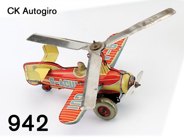 CK Autogiro: CK Autogiro lithographed tin clockwork, marked CK-Made in Japan, great action both props rotate as plane moves forward 5.5" ws.