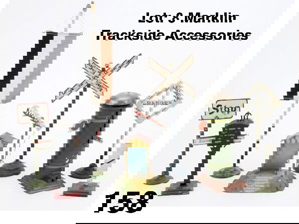 Lot: 8 Marklin Trackside Accessories: painted tin and cast grouping includes crossing keeper's hut with signal, flag pole, stop sign, 3 railroad crossing signs, signal bell and destination sign in German signage Size: flag pole 11.75" t.