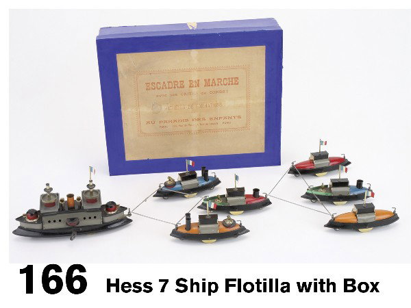 Hess 7 Ship Flotilla with Box: lithographed tin, largest with clockwork that pulls the other 6, complete with 7 different connecting rods for various formations, German made toy with paper label for French market Size: 8.25" l. and