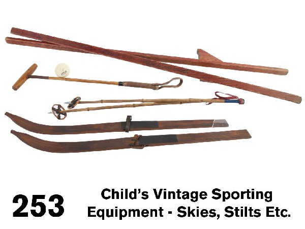 Child's Vintage Sporting Equipment - Skies, Stilts: circa 1910-1920's, included are a pair of child's red stained wood stilts stamped on sides "Pat pending...(indiscernible)....Lang - The shoe man-sells good shoes", a set of child's wooden skis with no