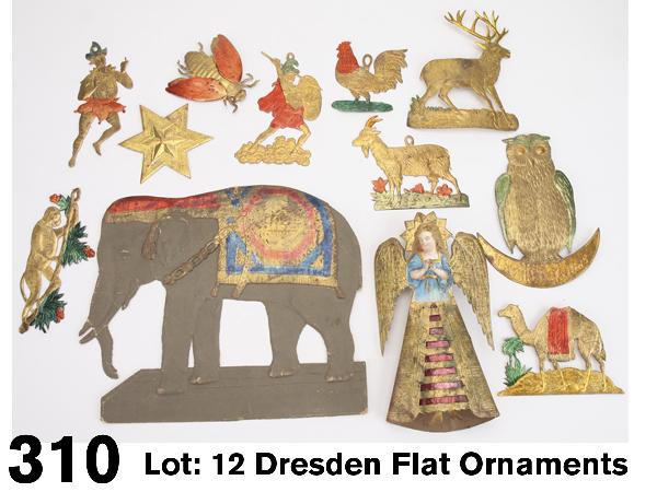 Lot: 12 Dresden Flat Ornaments: German, stamped and embossed cardboard one sided decorations in gold with red, blue and green metallic highlights; grouping includes angel tree topper with die cut image, embossed elephant with blanke