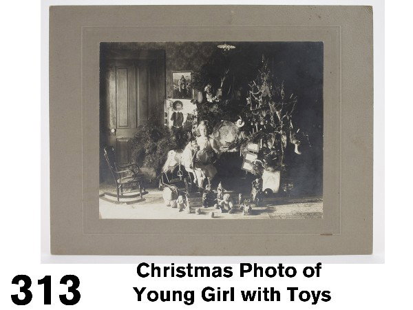 Christmas Photo of Young Girl with Toys: circa 1900, black and white photo of little girl posing beside the Christmas tree surrounded by toys including a Bliss ark, clown roly dolly, Schoenhut circus toys (clown, donkey, elephant), a nice Eu