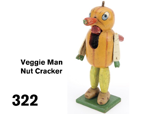 Veggie Man Nut Cracker: German, circa 1910-20, painted, carved and gessoed wood figure with pumpkin head, melon body, parsnip arms, carrot nose, cucumber legs and potato feet on painted wood base; a very unique holiday item 