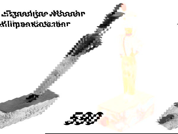 Erzgebirge Wooden Klimperkatschen: small klimperkatschen or carved wooden soldier standing at attention on paper covered wooden box base, figurewith black parade hat with wooden plume, navy blouse, white pants, and black boots; he carr