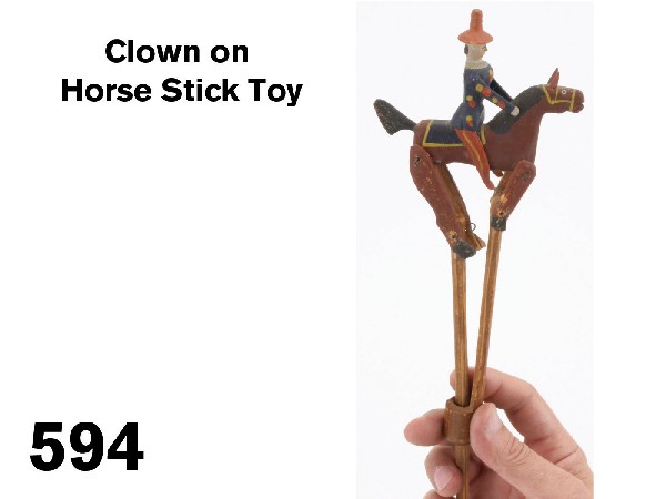 Clown on Horse Stick Toy: painted wood figure on articulated horse, typical Erzgebirge whimsical painting on the hatted figure - an early style with carved nose; pinned hinges on horse's shoulder and hooves create action when 