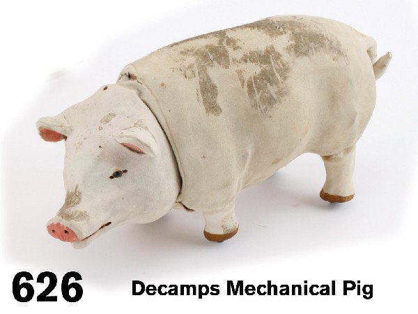 Decamps Mechanical Pig: French. circa 1900, hide covered paper mache animal with glass eyes and painted ears and snout; clockwork mechanism imparts walking motion with flanged wheel legs and nodding of head Size: 10.5" l.