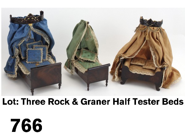 Lot: Three Rock & Graner Half Tester Beds: painted tin bed frames with embossed cornices with gold highlights; all are beautifully outfitted with silk and silk taffeta fabrics with lace and Dresden paper trims; fine details include bolsters, s