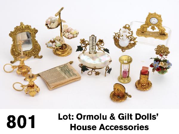Lot: Ormolu & Gilt Dolls' House Accessories: ormolu grouping includes 3 tier shell form centerpiece with bon bons, mantel clock, match holder, cigar cutter, easel back table mirror, pair candle holders; made by Erhard & Sohne, these items were a