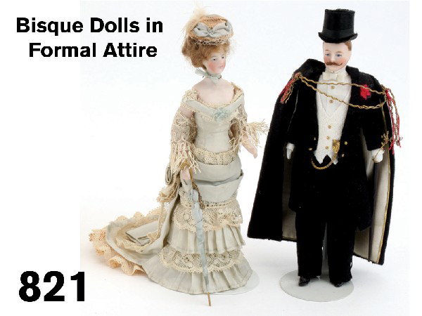 Bisque Dolls in Formal Attire: painted bisque dolls' house dolls dressed for an evening out-she in elaborate layered silk taffeta and lace gown complete with parasol and fringed shawl and he in white tie and tails with top hat and 