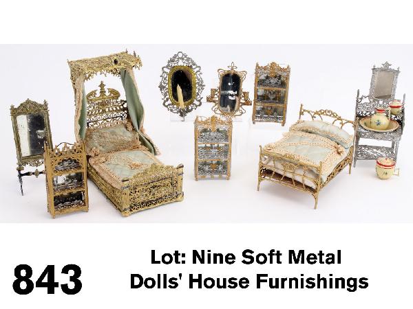 Lot: Nine Soft Metal Dolls' House Furnishings: gold and silver painted grouping by Schweitzer, Gerlach and other German makers includes ornate half tester bed with silk and lace trimmed curtains and bedding, smaller bed, also with silk and lace fi