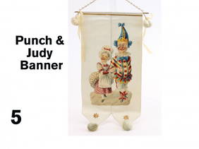 Punch & Judy Banner: embossed lithographed die cut image mounted on silk banner decorated with Dresden stars, ribbons and pom poms Size: 13" l.