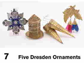 Five Dresden Ornaments: embossed heavy paper grouping includes a silvered iron cross with blue cellophane decoration, 2 candy cones, bird cage and leaves with fringed cellophane tassels Size: cones appr. 4" l.