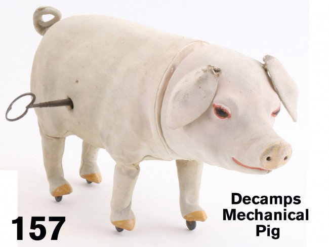 Decamps Mechanical Pig: hide covered composition figure with glass eyes and painted ears, snout and hooves; clockwork mechanism imparts walking motion, nodding head and squealing sounds with flanged wheel legs Size: 13" l.