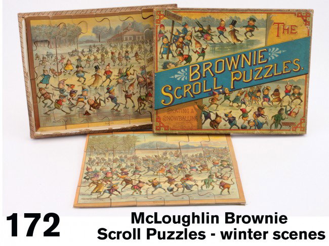 McLoughlin Brownie Scroll Puzzles - winter scenes: paper covered wooden box encloses 2 puzzles with Palmer Cox Brownie images: Skating and Snowballing - typical McLoughlin full color chromolithography offered in an above average example Size: 13.5" x 