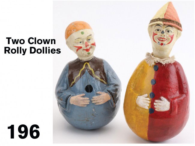 Lot: Two Clown Rolly Dollies: hand painted weighted papier mache roly toys with swivel heads; figure with felt hat retains cloth Schoenhut label, smaller unmarked but probably German Size: appr. 9.75" t. ea.