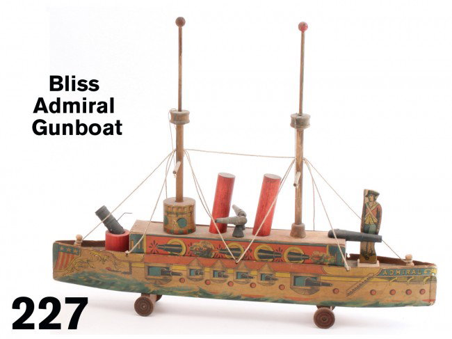 Bliss Admiral Gun Boat: lithographed paper on wood boat with 2 stacks, 3 deck guns and a functioning cannon on bow deck, paper appears all original with some fading, has colonial soldier figures possibly a target for the mar