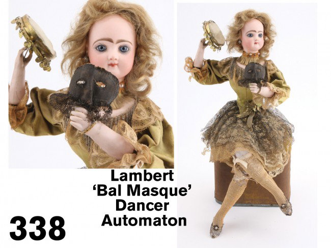 Lambert 'Bal Masque' Dancer Automaton: German bisque head seated dancer with closed mouth, stationary cornflower blue glass eyes, pieced ears, painted brows and lashes; she holds a mask in one hand and a tambourine in the other; she is sea