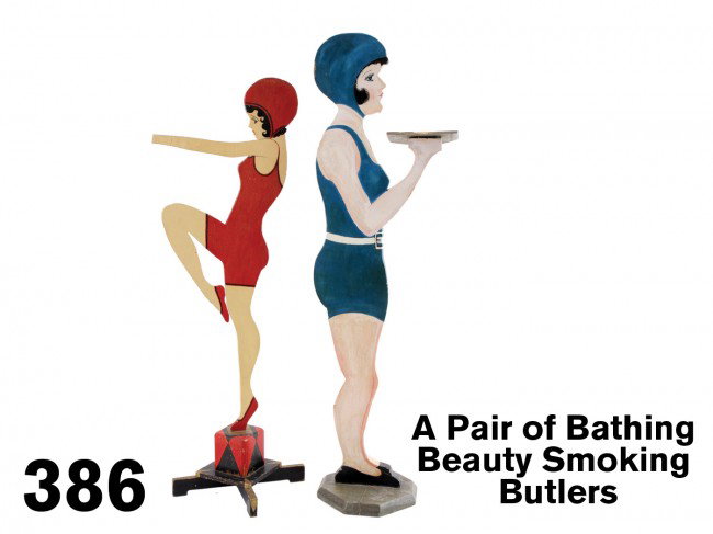 A Pair of Bathing Beauty Smoking Butlers: painted wood figures decorated on each side, the lady in red has no ashtray but stands on a finely crafted and painted art-deco style base, the lady in blue hods a flat tray that is missing a small se