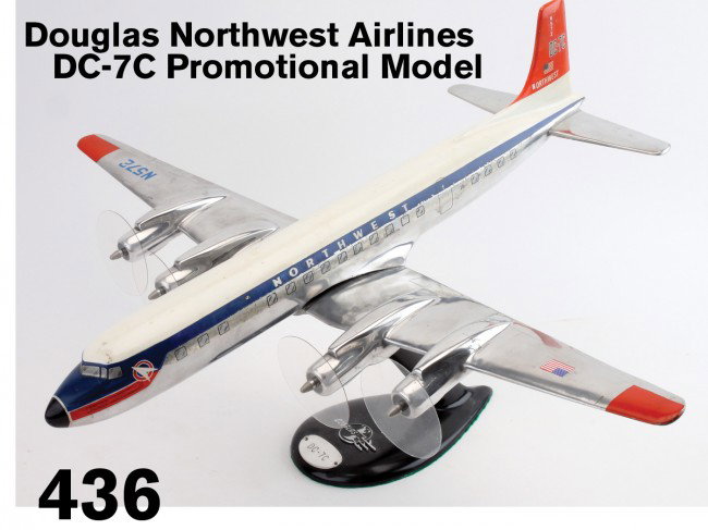 Douglas Northwest Airlines DC-7C Promotional Model: a very realistic cast aluminum model of a vintage propeller airliner, retains strong original decal decoration, original base has cast metal Douglas logo and model identification tag, Plexiglas discs 