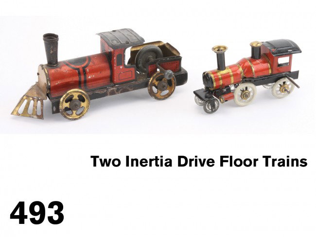 Two Inertia Drive Floor Trains: lithographed tin, both with inertia wheel friction power, both German - the smaller penny toy version is probably by Distler see Pressland Penny Toys - pg. 83 Size: 3.75" & 6.25" l.