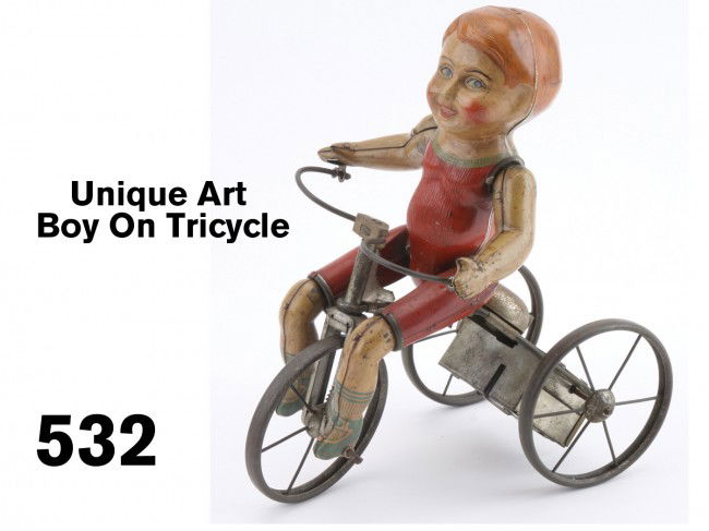 Unique Art Boy On Tricycle: lithographed tin with clockwork mechanism, this is the earlier (circa 1920) example of this popular toy with realistic pedaling action and ringing bell Size: 8" l.
