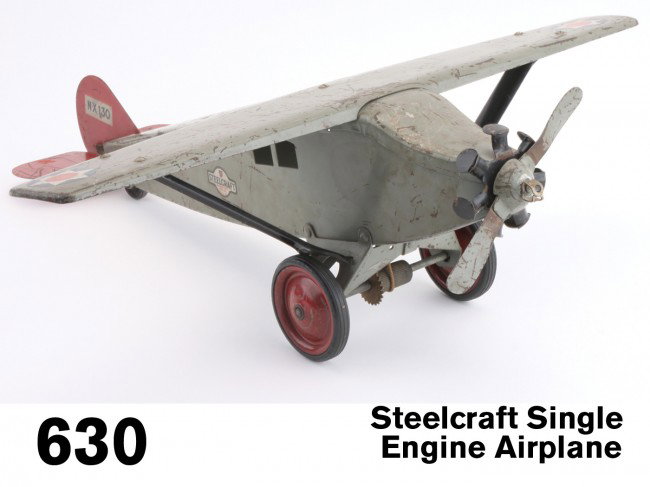 Steelcraft Single Engine Airplane: painted pressed steel with rubber tired wheels, retains maker's logo decal on each side, a nice original but well-played with example Size: 22.5" ws., 23" l.