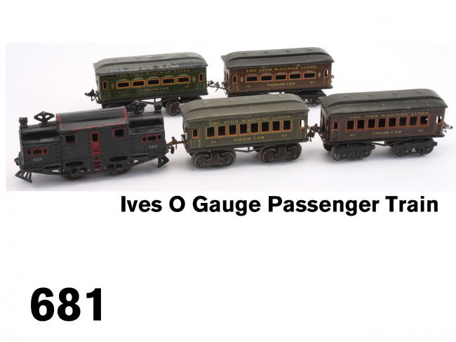 Ives O Gauge Passenger Train: painted cast iron locomotive #3217, electric powered, along with 4 lithographed tin coaches: two #62 Parlor Cars & two #61 Chair Cars - 1 each in green and brown Size: loco 7.5" l.