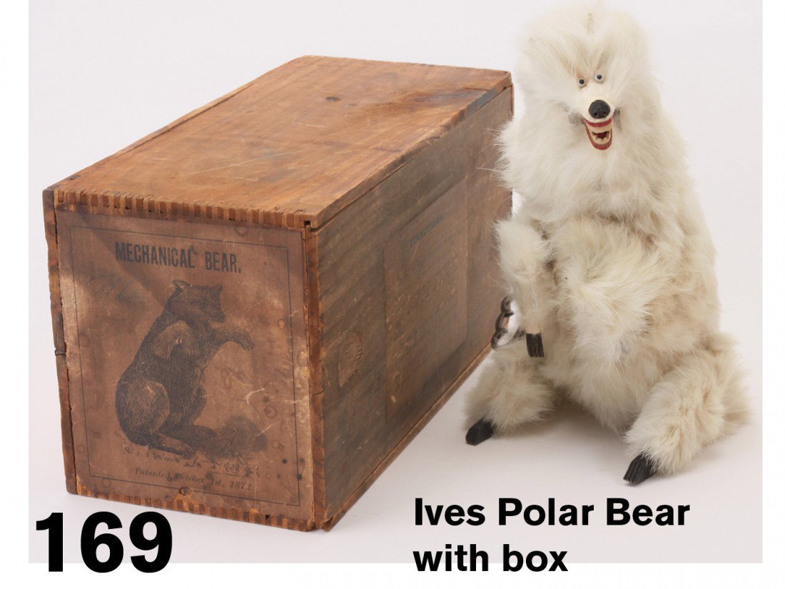 Ives Polar Bear with box: fur covered animal of various materials including wooden feet and claws, offered with original wood box with paper label depicting ferocious bear - internal clockwork mechanism: the bear moves his hea