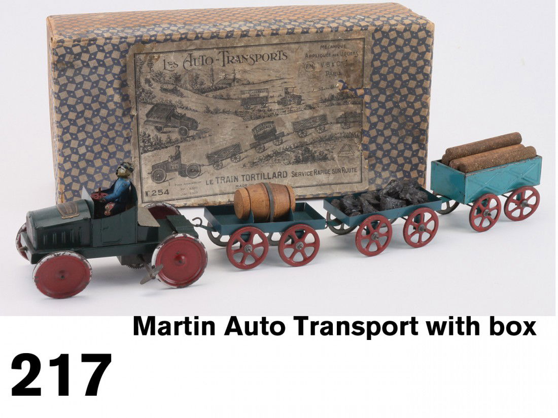 Martin Auto Transport with box: the motorized tractor with maker's identifying brass label on hood and painted tin driver pulls 3 cargo trailers: one with wine cask, one with coal load and one with lumber load, offered with original