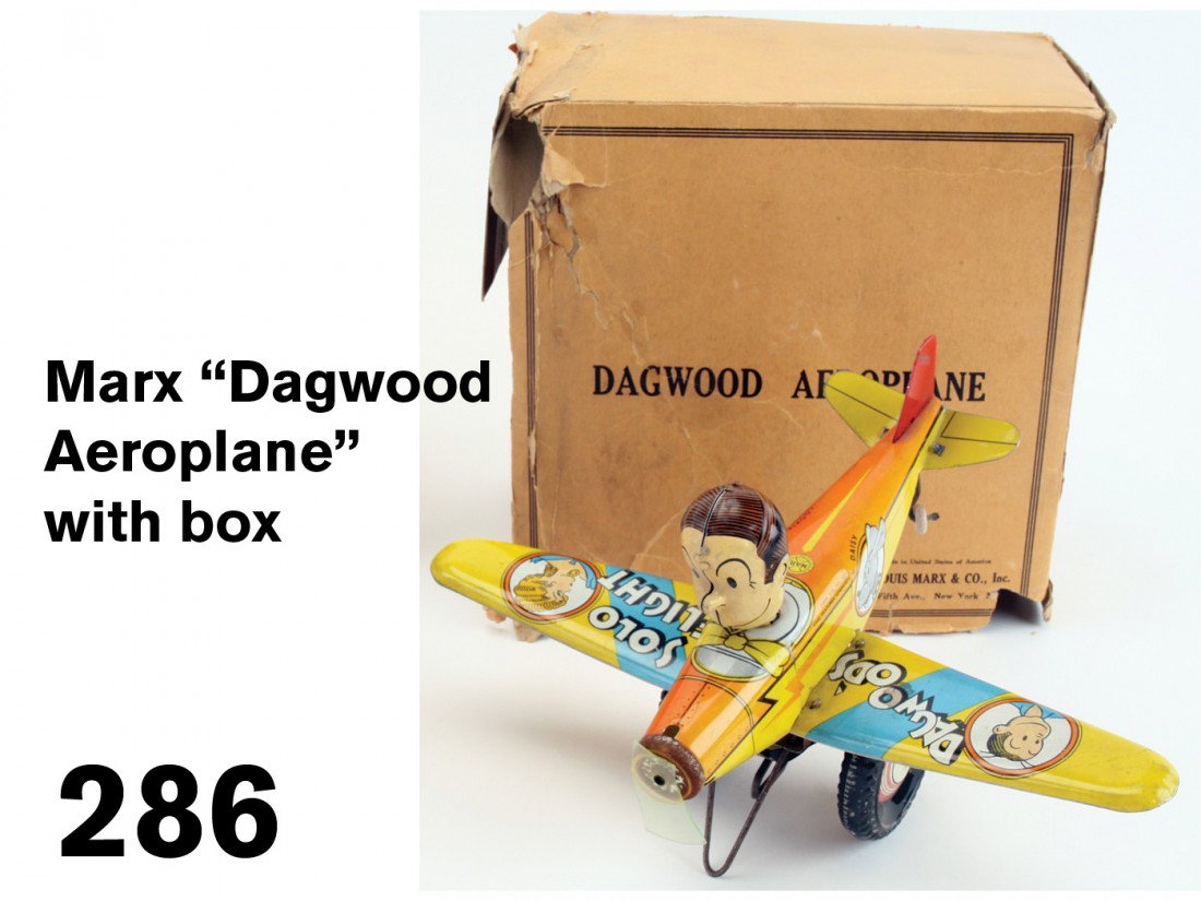 Marx 'Dagwood Aeroplane' with box: lithographed tin, clockwork, a colorful comic toy with comic strip illustrations on wings with original box; 12" ws.