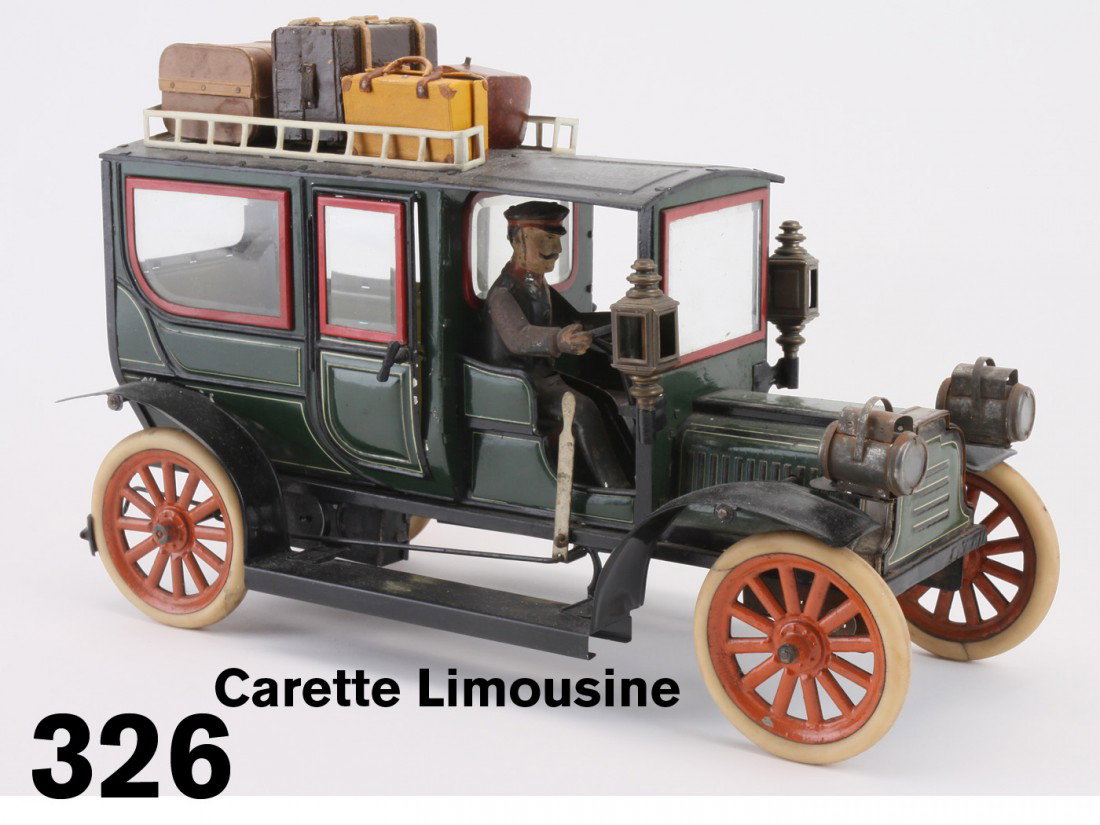 Carette Limousine: painted and lithographed tin limousine with painted tin driver ,robust clockwork mechanism, rubber tired wheels, beveled glass throughout, operating rear doors, headlamps and side lamps, offered with