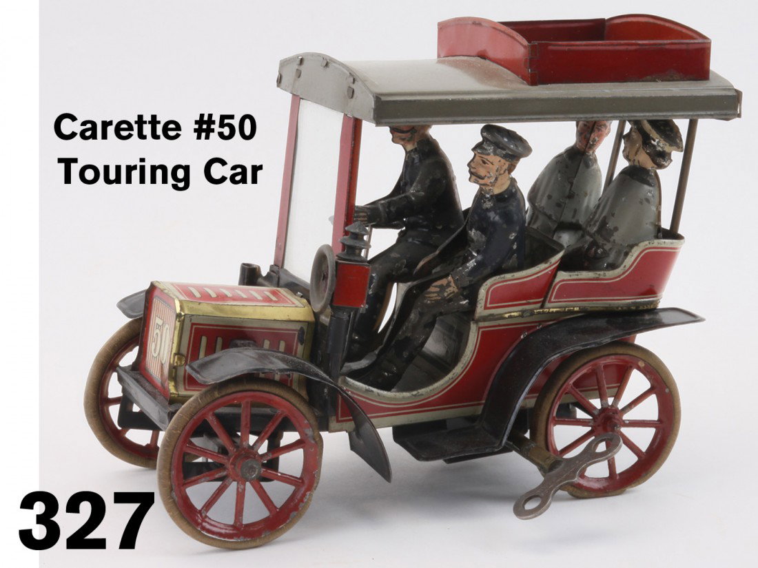 Carette #50 Touring Car: German automotive toy offered in original condition; the lithographed tin clockwork auto has hand painted tin figures, rubber tires and glass windshield; this example needs a little straightening up a