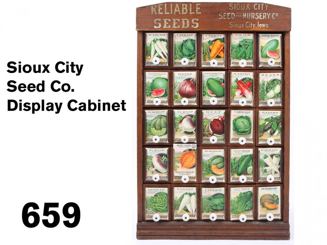 Sioux City Seed Co. Display Cabinet: stained wood store display cabinet with 25 galvanized steel drawers with wood backs and fronts with slots for seed packet display, outfitted with an array of colorful 'Reliable Seeds' packets ; 11.5"
