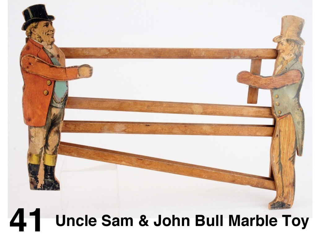 Uncle Sam & John Bull Marble Toy: lithographed paper on wood figures flank the marble roll Size: 21" w.