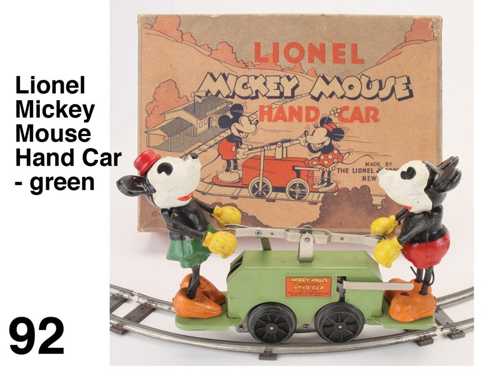 Lionel Mickey Mouse Hand Car - green: No. 1100 painted tin clockwork handcar with composition Mickey & Minnie, full circle of track in original illustrated box Size: car 7.5" l.