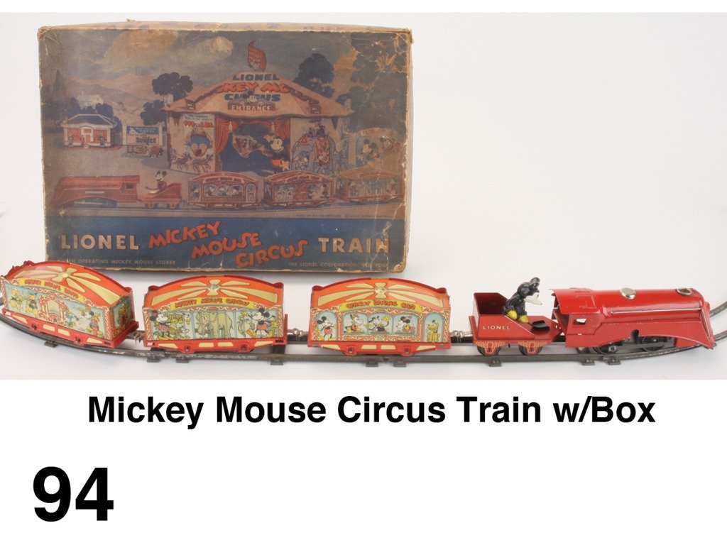Mickey Mouse Circus Train w/Box: clockwork engine with animated Mickey stoker pulls 3 colorful lithographed tin circus cars, track and colorful lithographed box Size: box 17" x 11"